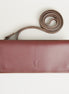 Front view of horizontal full-grain leather crossbody bag and matching shoulder strap in Espresso Brown, showing handmade stitching and embossed logo. Markore Gul Sahar.