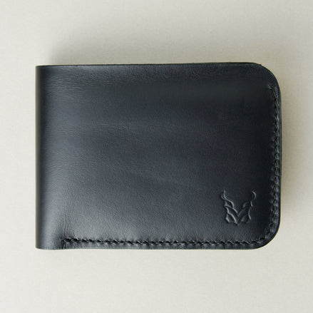 Front view of full grain leather bifold wallet in midnight black featuring handmade stitching and embossed logo. Markore Hunza Fold.