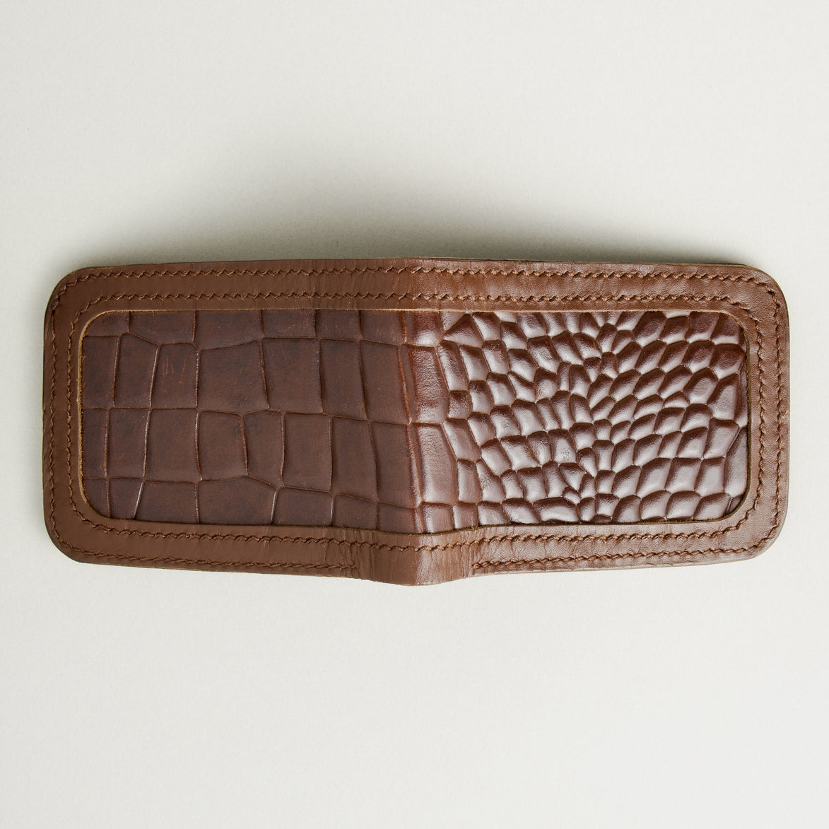 Outside view of espresso brown croc-embossed full-grain leather bifold wallet featuring handmade stitching. Markore Indus Sultan