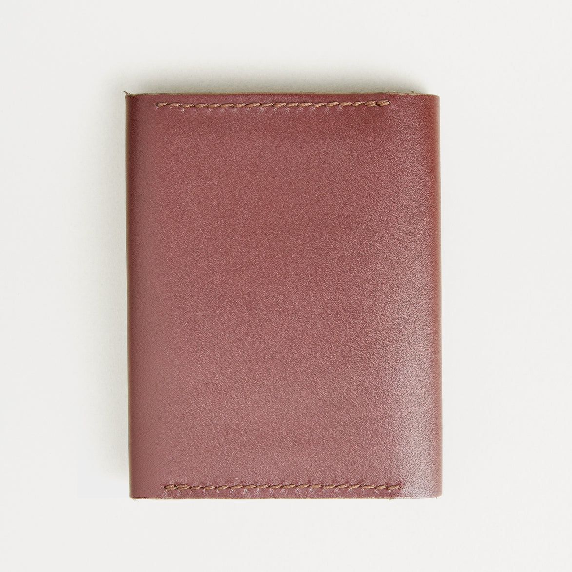 Back view of espresso brown full-grain leather flap fold wallet featuring handmade stitching. Markore Khaas Andaz.