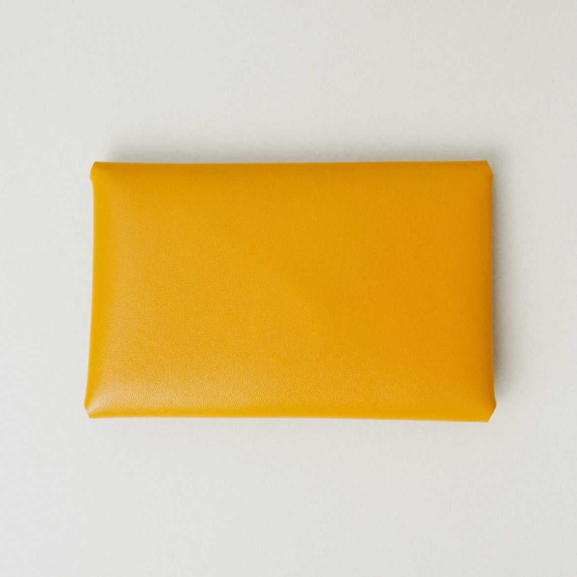 Back view of full grain leather envelope style wallet in amber. Markore Niva Seal.