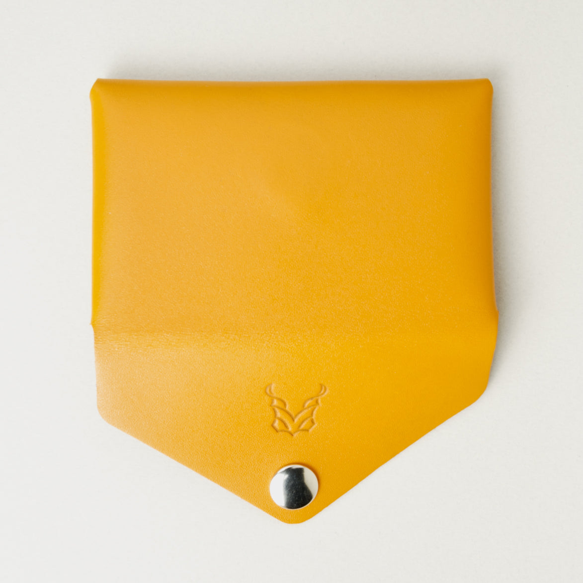 Back view of full grain leather envelope style wallet with open flap in amber with stainless steal press button. Markore Niva Seal.