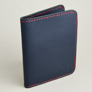 Side view of dark blue full-grain leather wallet featuring red handmade stitching and embossed logo. Markore Ravi Fold.