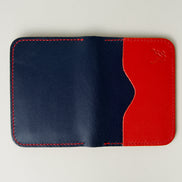 Outside view of dark blue full-grain leather wallet featuring red card slot, red handmade stitching and embossed logo. Markore Ravi Slip.