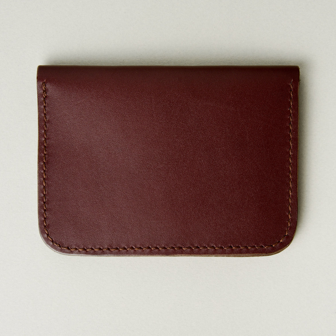 Back view of espresso full-grain leather wallet featuring handmade stitching. Markore Ravi Slip.