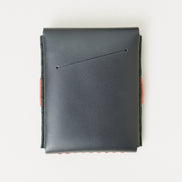 Back view of midnight black full-grain leather flap wallet a card slot and red handmade stitching. Markore Sutlej Vault.