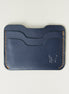 Front view of dark blue full-grain leather card sleeve featuring card slots, amber handmade stitching and embossed logo. Markore Niva Zoj.