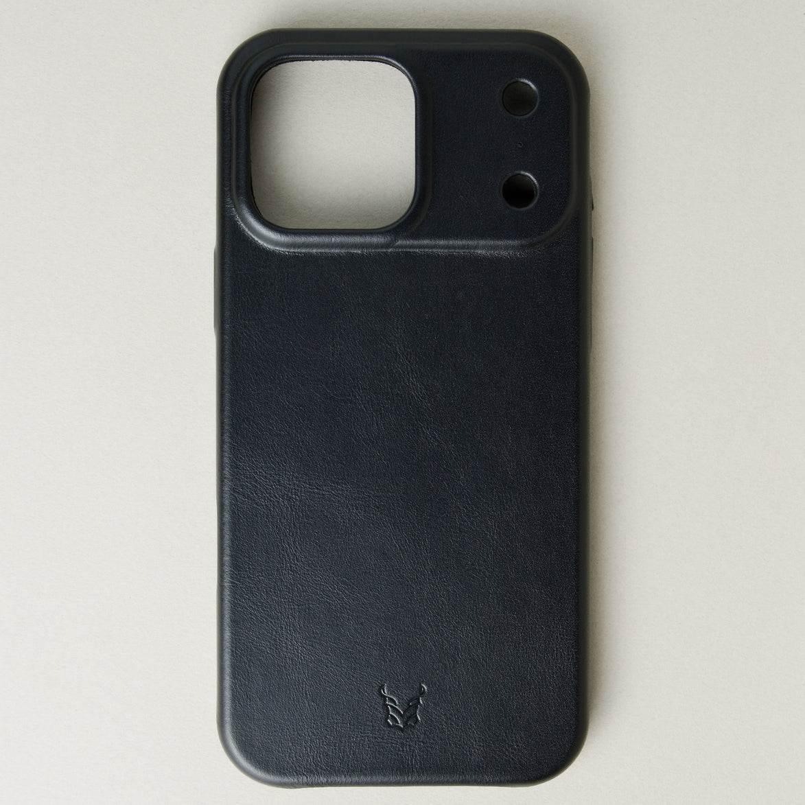 Outside view of midnight black leather iPhone 17 cover showing embossed brand logo. Markore Shell Guard.